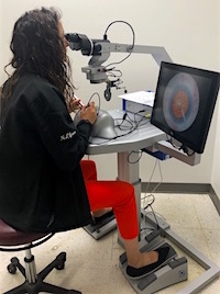 person using eye surgery simulator