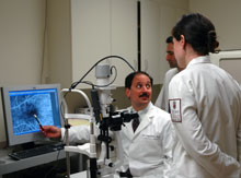 Dr. Salvatore J. Loporchio reviews a fluorescein angiogram with residents at the VA Eye Clinic.